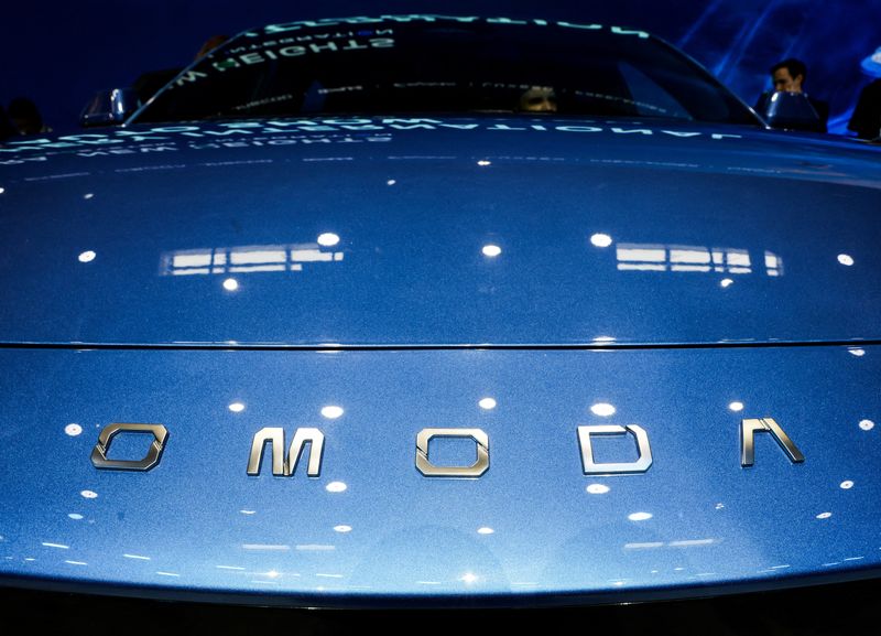 FILE PHOTO: A logo of Chery’s brand Omoda appears on a car as people sit inside at the company’s booth at the Beijing International Automotive Exhibition (Auto China), in Beijing, April 24, 2026. REUTERS/Maxim Shemetov/File Photo