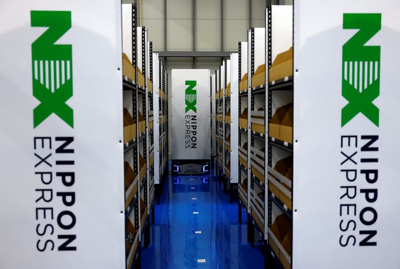 Nippon Express (NX) demonstrates the robots carrying shelves 'EVE' at the NX Auto Logistics Facility, which enables senior citizens and people with disabilities to handle the work amid an acute labour shortage in Japan, during a media tour in Tokyo, Japan November 28, 2024.  REUTERS/Issei Kato