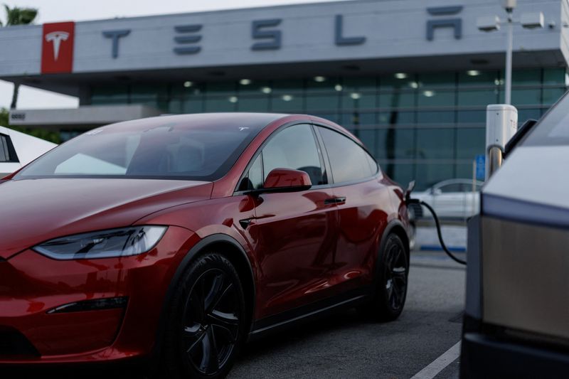 A Tesla model Y is shown charging at a Tesla dealership in Buena Park, California, U.S., January 28, 2026. REUTERS/Mike Blake