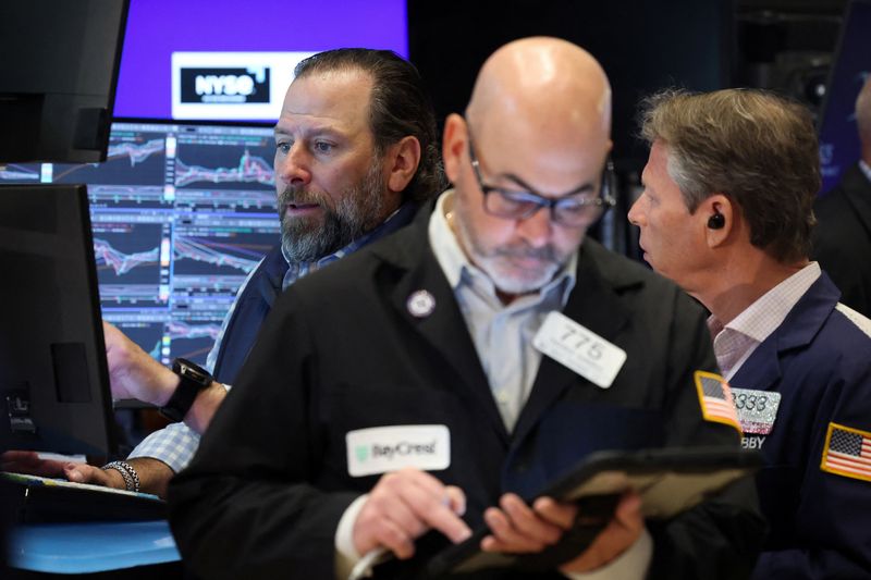 Traders work on the floor at the New York Stock Exchange (NYSE) in New York City, U.S., April 27, 2026.  REUTERS/Brendan McDermid