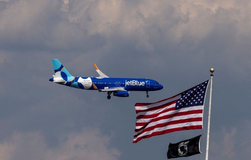 FILE PHOTO: A JetBlue Airlines commercial aircraft flies over Washington as it approaches to land at Dulles International Airport, as seen from Washington, U.S., August 5, 2024. REUTERS/ Umit Bektas/File Photo