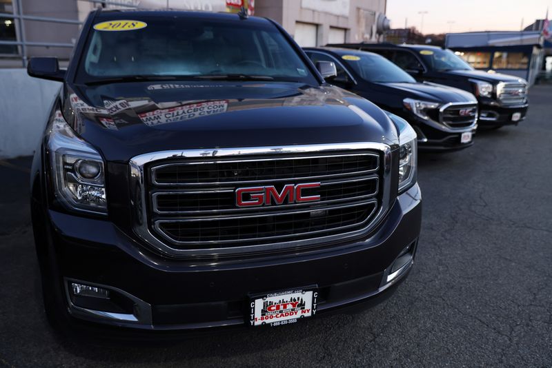 FILE PHOTO: Vehicles from GMC, an automobile brand owned by General Motors Company, are seen for sale at a car dealership in Queens, New York, U.S., November 16, 2021. REUTERS/Andrew Kelly/File Photo