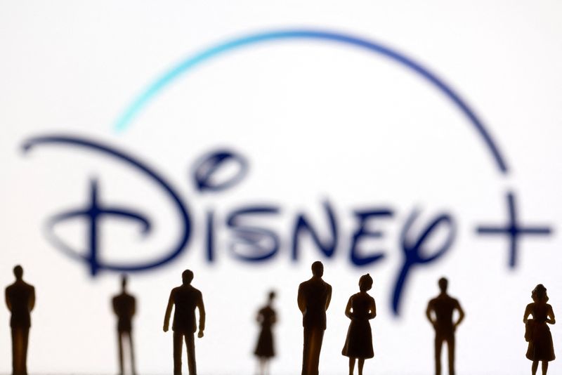 Toy figures of people are seen in front of the displayed Disney + logo, in this illustration taken January 20, 2022. REUTERS/Dado Ruvic/Illustration