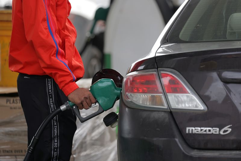 A person uses a petrol pump at a gas station as fuel prices surged in Manhattan, New York City, U.S., March 7, 2022. REUTERS/Andrew Kelly/File Photo
