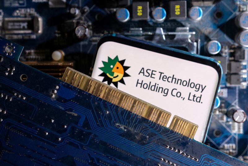 A smartphone with a displayed ASE Technology Holding logo is placed on a computer motherboard in this illustration taken March 6, 2023. REUTERS/Dado Ruvic/Illustration