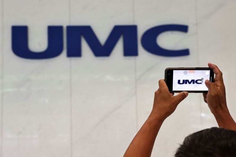A member of the media takes video of United Microelectronics Corporation (UMC) logo at the company’s lobby at Hsinchu Science Park in Hsinchu, Taiwan, September 16, 2022.  REUTERS/Ann Wang
