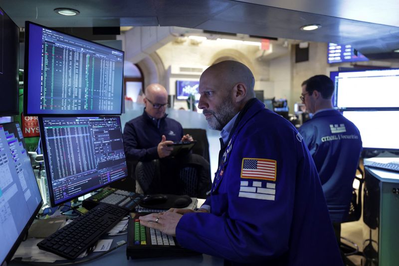 Traders work on the floor at the New York Stock Exchange (NYSE) in New York City, U.S., April 23, 2026. REUTERS/Jeenah Moon