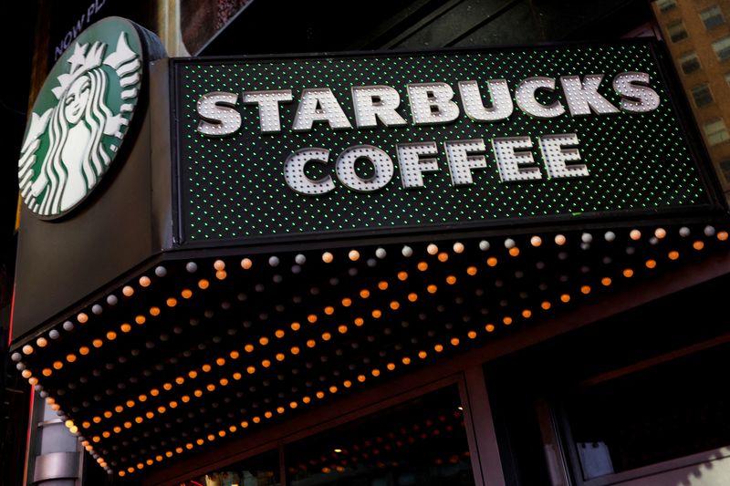 FILE PHOTO: A Starbucks store entrance sign is seen at Times Square in New York City, U.S., February 25, 2025. REUTERS/Shannon Stapleton/File Photo