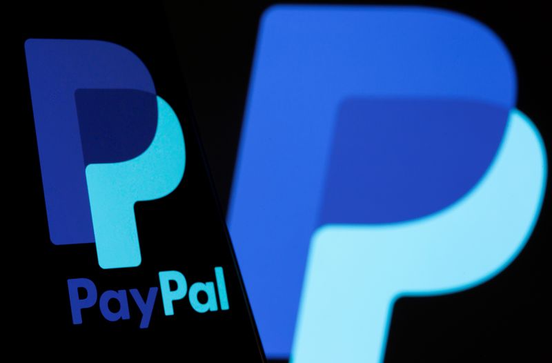 The PayPal logo is seen on a smartphone in front of the same logo displayed in this illustration taken September 8, 2021. REUTERS/Dado Ruvic/Illustration