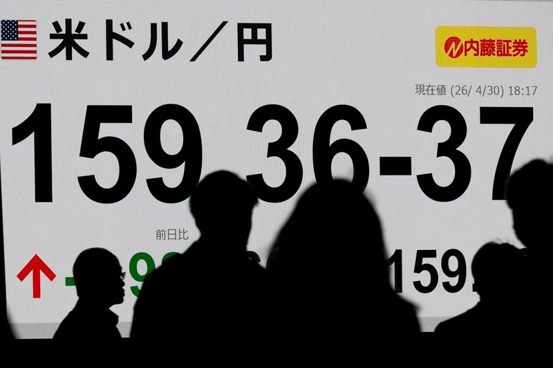 Pedestrians walk past a stock quotation board showing the exchange rate between the U.S. dollar and the Japanese yen outside a brokerage in Tokyo, Japan,April 30, 2026. REUTERS/Kim Kyung-Hoon