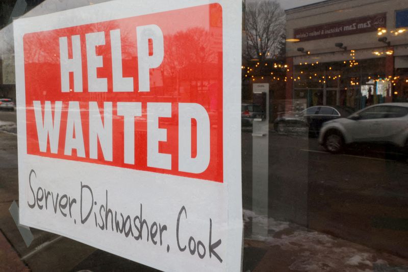 FILE PHOTO: A “Help Wanted” sign hangs in restaurant window in Medford, Massachusetts, U.S., January 25, 2023. REUTERS/Brian Snyder/File Photo