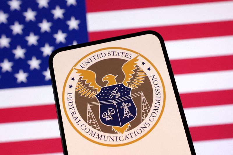 FILE PHOTO: United States Federal Communications Commission logo and U.S. flag are seen in this illustration taken April 23, 2025. REUTERS/Dado Ruvic/Illustration/File Photo