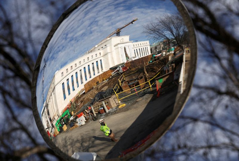FILE PHOTO: A mirror reflects the construction site of the Federal Reserve headquarters in Washington, D.C., U.S., January 12, 2026. REUTERS/Kevin Lamarque/File Photo