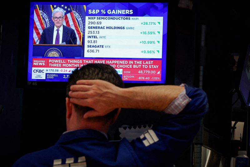 A trader works, as a screen broadcasts a news conference by U.S. Federal Reserve Chair Jerome Powell following the Fed rate announcement, on the floor of the New York Stock Exchange (NYSE) in New York City, U.S., April 29, 2026.  REUTERS/Brendan McDermid