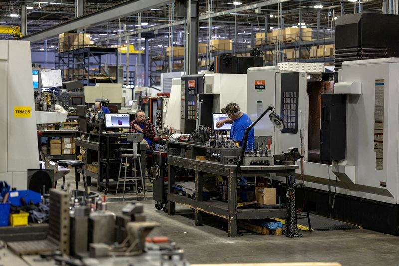 FILE PHOTO: Employees work on the production floor of the General Stamping & Metalworks building in South Bend, Indiana, U.S., March 23, 2026. REUTERS/Jim Vondruska/File Photo
