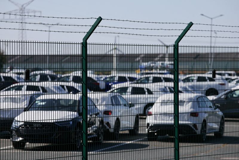 Cars of the Volkswagen Group intended for export to the United States are seen behind a fence at the seaport of Emden near the estuary, where the River Ems flows into the North Sea, in Emden, Germany, April 2, 2025. REUTERS/Wolfgang Rattay