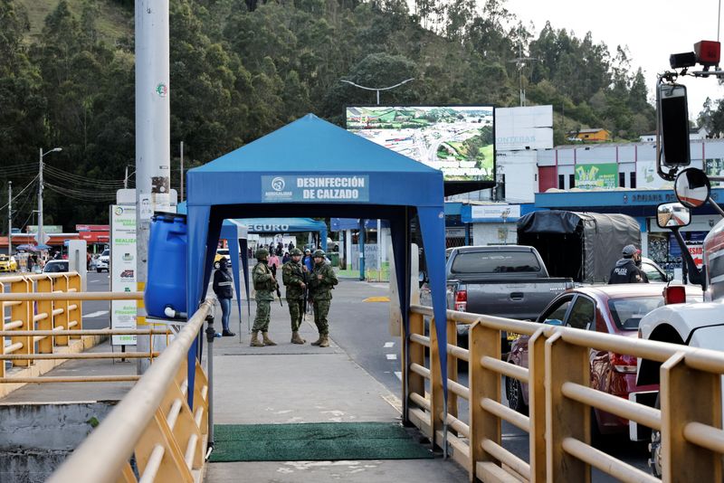 Military personnel stand guard at the Rumichaca International Bridge at the border between Ecuador and Colombia as local merchants report a decline in trade, after Ecuador's government on Thursday said it was raising tariffs on imports from its larger neighbor Colombia to 100% from a prior level of 50%, citing Colombia's alleged failure to implement border security measures, in Tulcan, Ecuador, April 30, 2026. REUTERS/Karen Toro