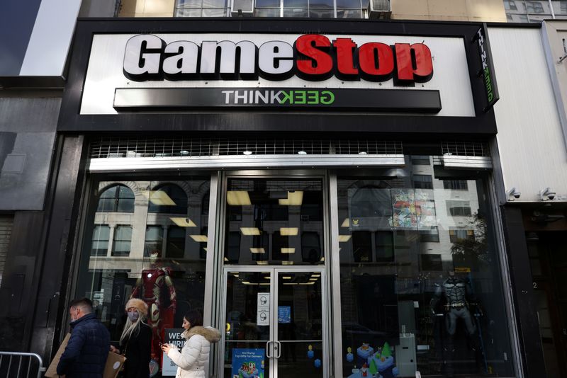 People walk by a GameStop in Manhattan, New York, U.S., December 7, 2021. REUTERS/Andrew Kelly