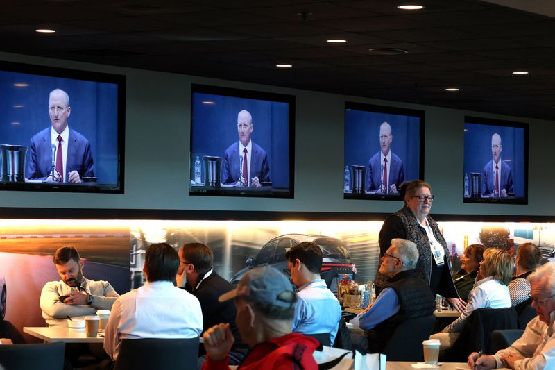 Shareholders watch screens as Berkshire Hathaway CEO Greg Abel addresses the Berkshire Hathaway Inc’s annual shareholders meeting, the conglomerate’s first since Warren Buffett stepped down after 60 years as chief executive and was succeeded by Abel, in Omaha, Nebraska, U.S., May 2, 2026. REUTERS/Brendan McDermid
