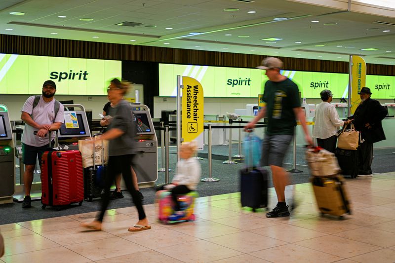 Passengers walk at Orlando International Airport, as Spirit Airlines announced it was ceasing operations early Saturday morning following an impasse in talks with some creditors on a $500 million government bailout plan, in Orlando, Florida, U.S., May 2, 2026. REUTERS/Miguel Rodriguez