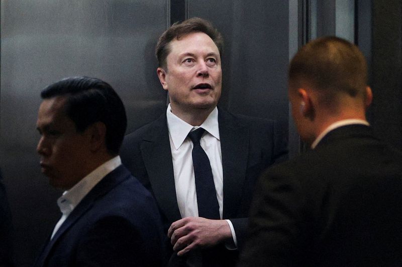 FILE PHOTO: Elon Musk stands in an elevator to attend the trial in his lawsuit over OpenAI for-profit conversion at a federal courthouse, in Oakland, California, U.S., April 30, 2026.  REUTERS/Manuel Orbegozo/File Photo