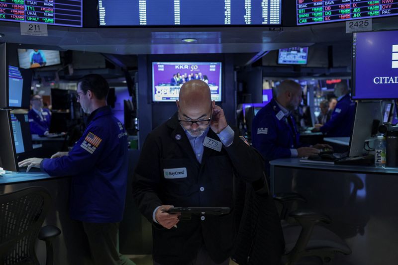Traders work on the floor at the New York Stock Exchange (NYSE) in New York City, U.S., May 1, 2026. REUTERS/Jeenah Moon/File Photo