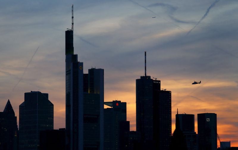 FILE PHOTO: The famous skyline with its banking district is pictured as a rescue helicopter flies by in Frankfurt early evening April 13, 2015. The European Central Bank's governing council will meet in Frankfurt on Wednesday, April 15.  REUTERS/Kai Pfaffenbach/File Photo