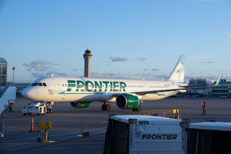 The air traffic control tower is seen as a Frontier flight pulls away from the gate at the Denver International Airport terminal, in Denver, Colorado, U.S., May 15, 2025.  REUTERS/Megan Varner/File Photo