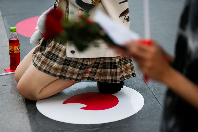 A woman kneels down to pray at a "Pray and swipe right" event organised by online dating app Tinder at the Trimuriti shrine on Valentine's Day in Bangkok, Thailand February 14, 2022. REUTERS/Soe Zeya Tun