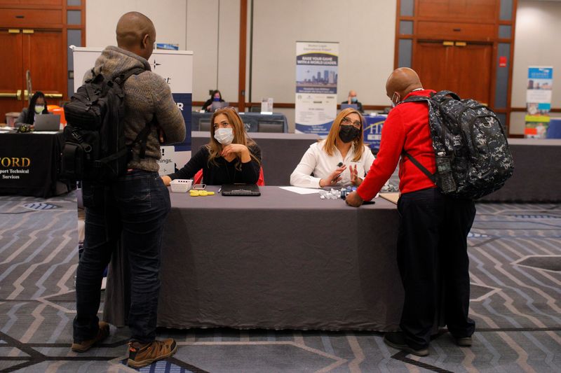 Job seekers talk to representatives at a job fair at Logan International Airport in Boston, Massachusetts, U.S., December 7, 2021.   REUTERS/Brian Snyder/File Photo