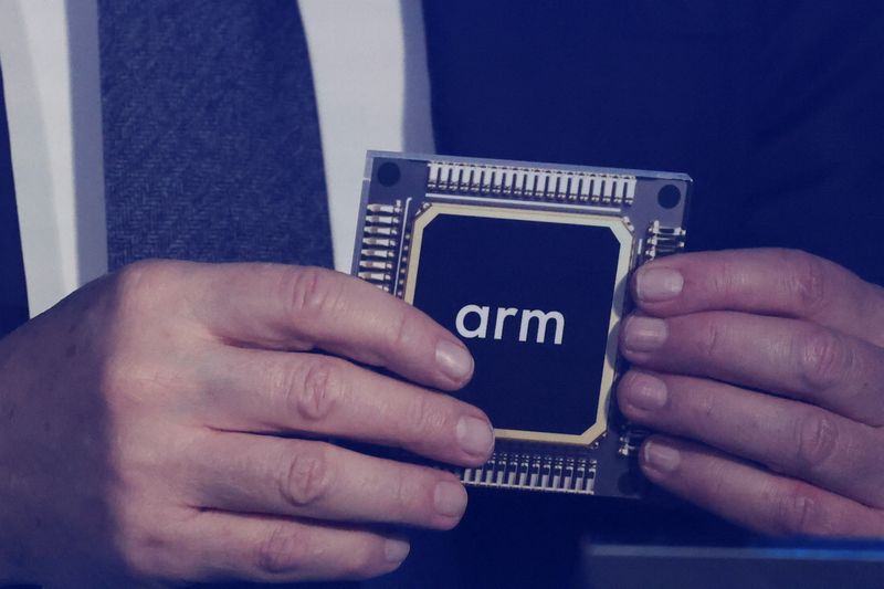 Rene Haas, CEO of chip tech provider Arm Holdings, holds a replica of a chip with his company's logo on it, during an event in which Malaysia's Prime Minister Anwar Ibrahim officially announces a $250 million deal with the company, in Kuala Lumpur, Malaysia March 5, 2025. REUTERS/Hasnoor Hussain