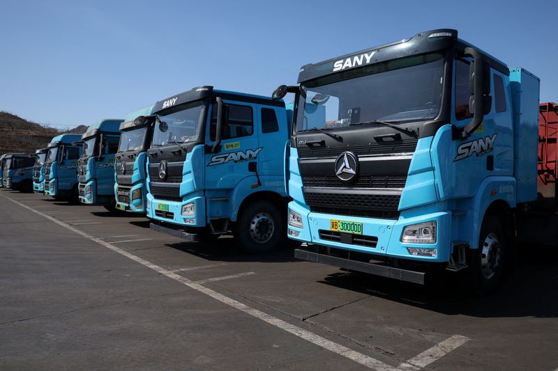 FILE PHOTO: Sany electric heavy trucks are parked at a fleet depot equipped with electric truck charger, in Tangshan, Hebei province, China, April 1, 2026. REUTERS/Tingshu Wang/File Photo