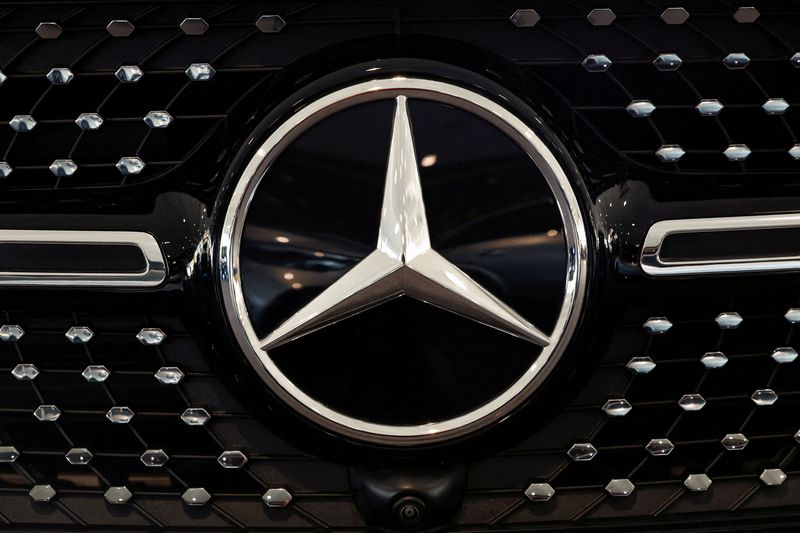 FILE PHOTO: A logo of Mercedes-Benz is seen inside a Mercedes-Benz car dealer in Arnhem, Netherlands February 18, 2025. REUTERS/Piroschka van de Wouw/File Photo