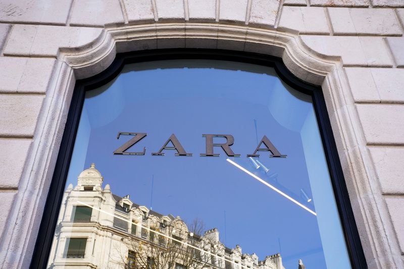 A building is reflected in the window of a Zara clothes store, part of the Spanish Inditex group, in Bilbao, Spain, November 30, 2021. REUTERS/Vincent West