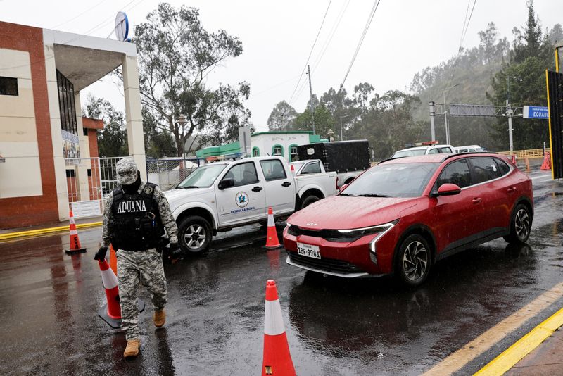 FILE PHOTO: Vehicles pass through a customs checkpoint as local merchants report a decline in trade, after Ecuador's government said it was raising tariffs on imports from its larger neighbor Colombia to 100% from a prior level of 50%, citing Colombia's alleged failure to implement border security measures, in Tulcan, Ecuador, May 1, 2026. REUTERS/Karen Toro/File Photo