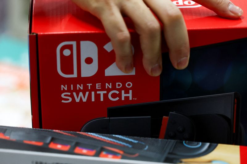 A person holds a Nintendo Switch 2 game console's box as Nintendo starts selling the new consoles globally, at an electronics store in Tokyo, Japan June 5, 2025.  REUTERS/Issei Kato