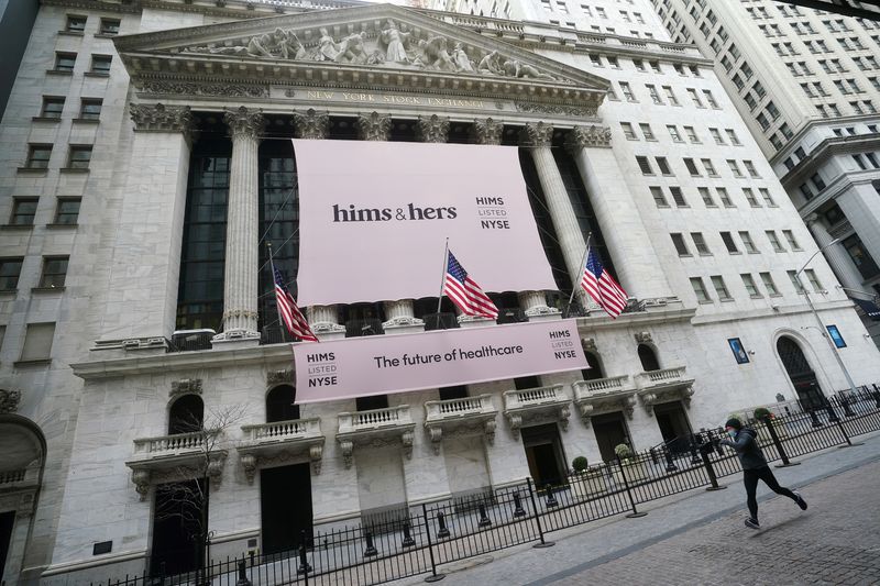 The New York Stock Exchange with a Hims & Hers Health, Inc banner is pictured as a person runs past in the Manhattan borough of New York City, New York, U.S., January  21, 2021. REUTERS/Carlo Allegri