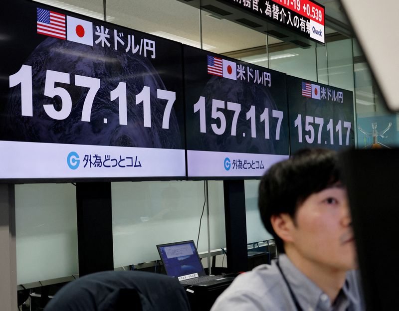 FILE PHOTO: An employee of the foreign exchange trading company Gaitame.com works in front of monitors displaying the current Japanese yen exchange rate against the U.S. dollar, at their dealing room in Tokyo, Japan May 1, 2026. REUTERS/Kim Kyung-Hoon/File Photo