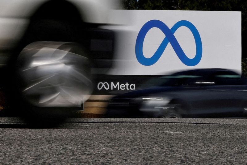 FILE PHOTO: Cars drive past a sign of Meta at its headquarters in Menlo Park, California, U.S. October 28, 2021. REUTERS/Carlos Barria/File Photo