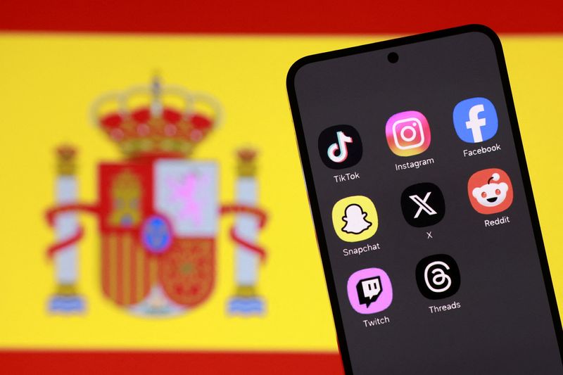 A Spanish flag and smartphone with displayed social media app icons are seen in this illustration taken February 3, 2026. REUTERS/Dado Ruvic/Illustration