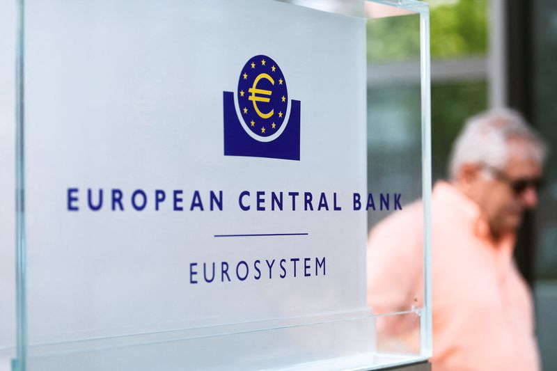 A man walks by a sign in front of the European Central Bank (ECB) building, in Frankfurt, Germany, July 21, 2022. REUTERS/Wolfgang Rattay