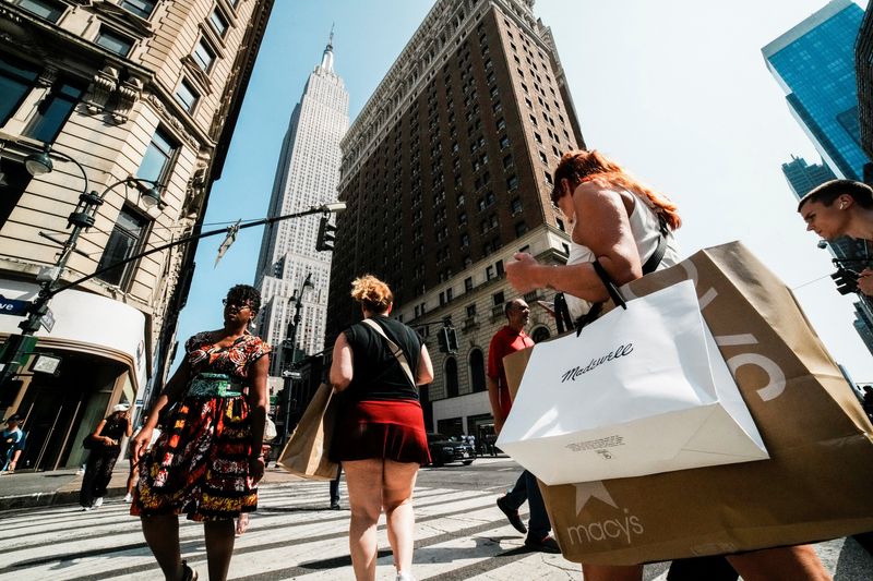 A woman carries shopping bags in Manhattan in New York City, U.S., August 11, 2025. REUTERS/Eduardo Munoz