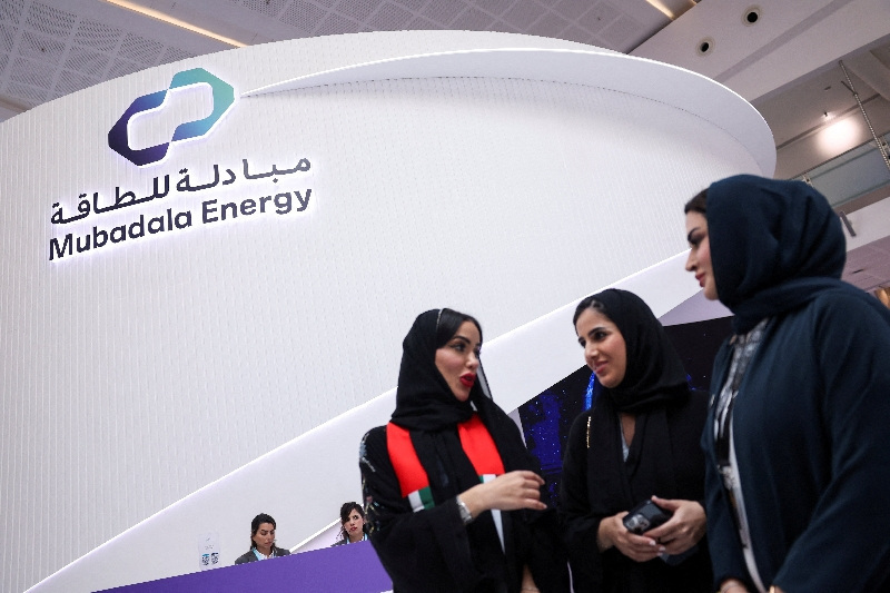 FILE PHOTO: People stand near the booth of Mubadala Energy during the annual energy industry event Abu Dhabi International Petroleum Exhibition and Conference (ADIPEC) in Abu Dhabi, United Arab Emirates, November 3, 2025. REUTERS/Amr Alfiky/File Photo