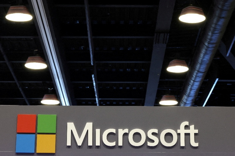 FILE PHOTO: The logo of Microsoft is displayed over a booth at the Web Summit digital trade show in Vancouver, British Columbia, Canada, May 12, 2026.   REUTERS/Chris Helgren/File Photo