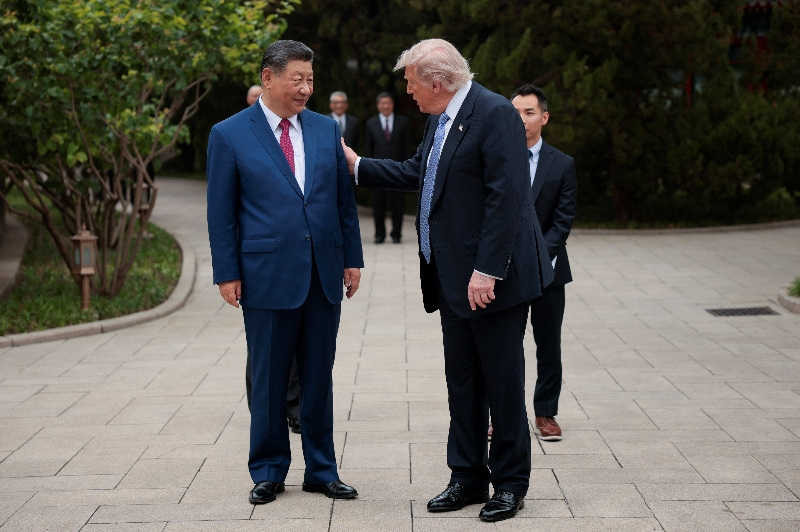 U.S. President Donald Trump speaks with Chinese President Xi Jinping while leaving after a visit to the Zhongnanhai Garden in Beijing, China, May 15, 2026. REUTERS/Evan Vucci/Pool