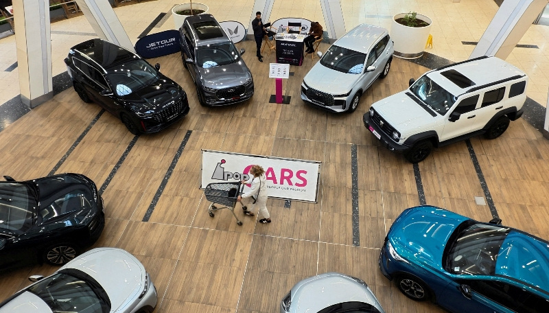 FILE PHOTO: A shopper pushes a trolley past models of Chinese car brands, including Chery and Omoda, on display at a shopping mall in Johannesburg, South Africa April 23, 2026. REUTERS/Siphiwe Sibeko/File Photo