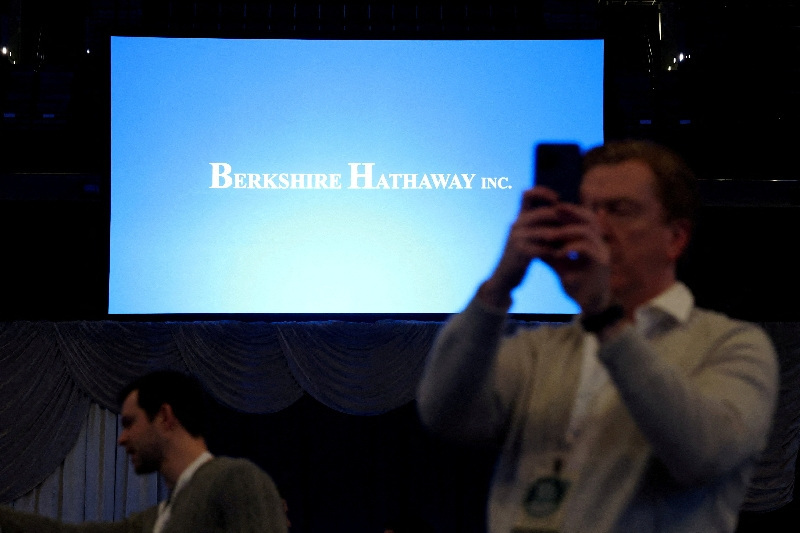 FILE PHOTO: A man uses a phone as shareholders attend the Berkshire Hathaway Inc. annual shareholders' meeting in Omaha, Nebraska, U.S., May 2, 2026. REUTERS/Brendan McDermid/File Photo