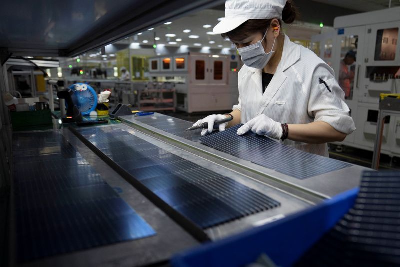 An employee works on the production line for solar panels at a factory of GCL System Integration Technology in Hefei, Anhui province, China May 16, 2024.  China Daily via REUTERS