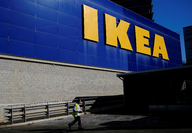 FILE PHOTO: A worker walks past a logo of IKEA on the facade of an IKEA store in Barcelona, Spain April 26, 2024. REUTERS/Nacho Doce/File Photo