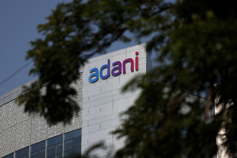 FILE PHOTO: FILE PHOTO: The logo of the Adani Group is seen on the facade of its Corporate House on the outskirts of Ahmedabad, India, November 21, 2024. REUTERS/Amit Dave/File Photo/File Photo